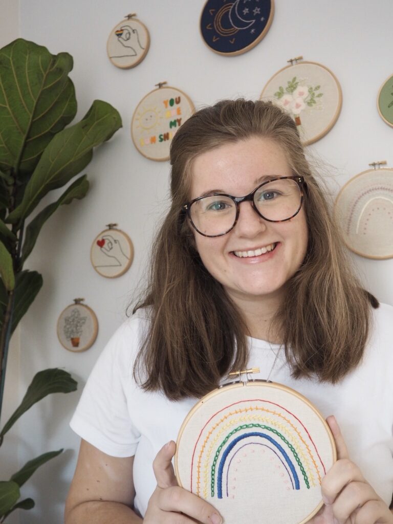Jess from Thimble and Fabric, holding one of her embroidery kits