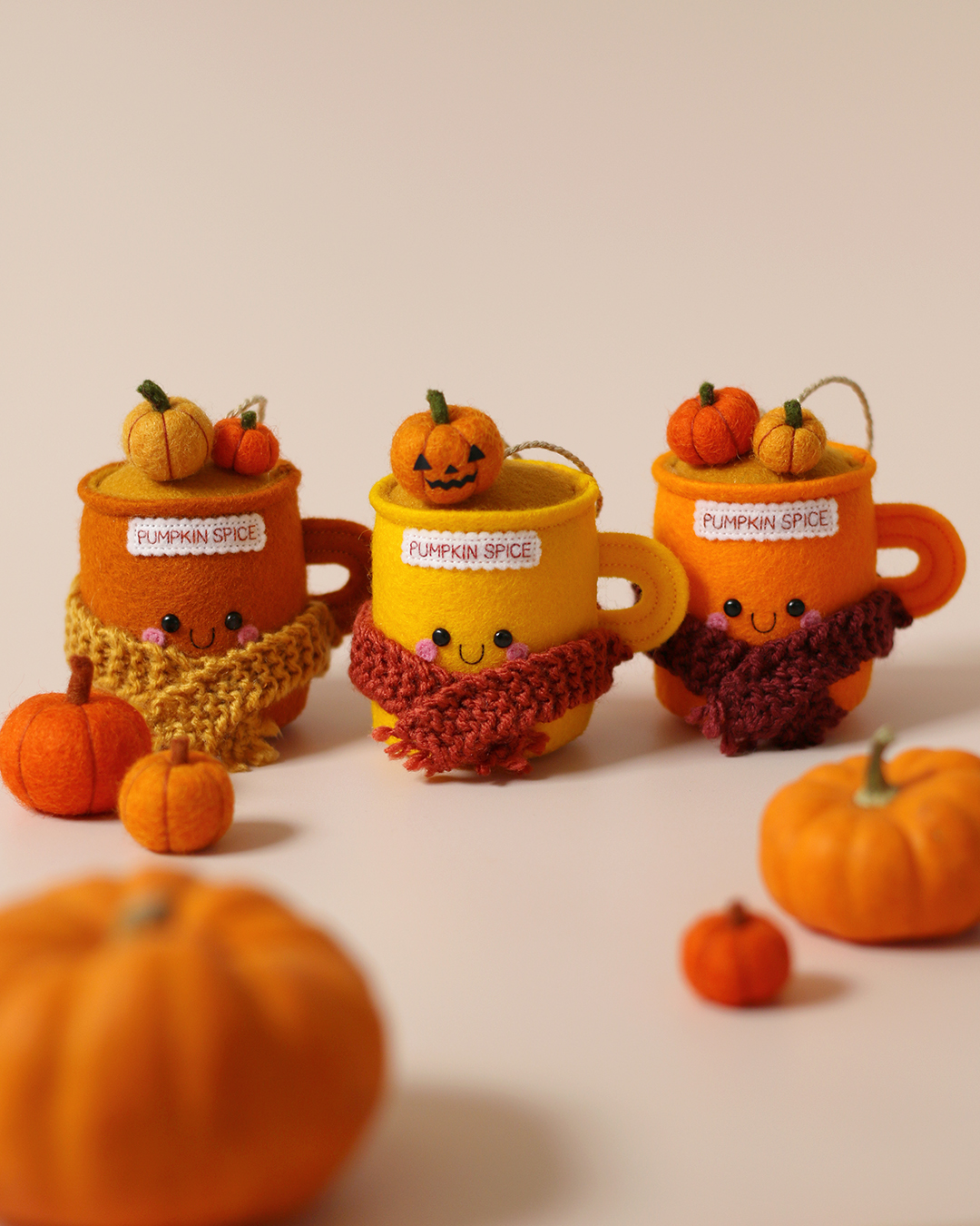 Pumpkin spice felt mug ornaments with little faces and scarfs by hannahdoodle
