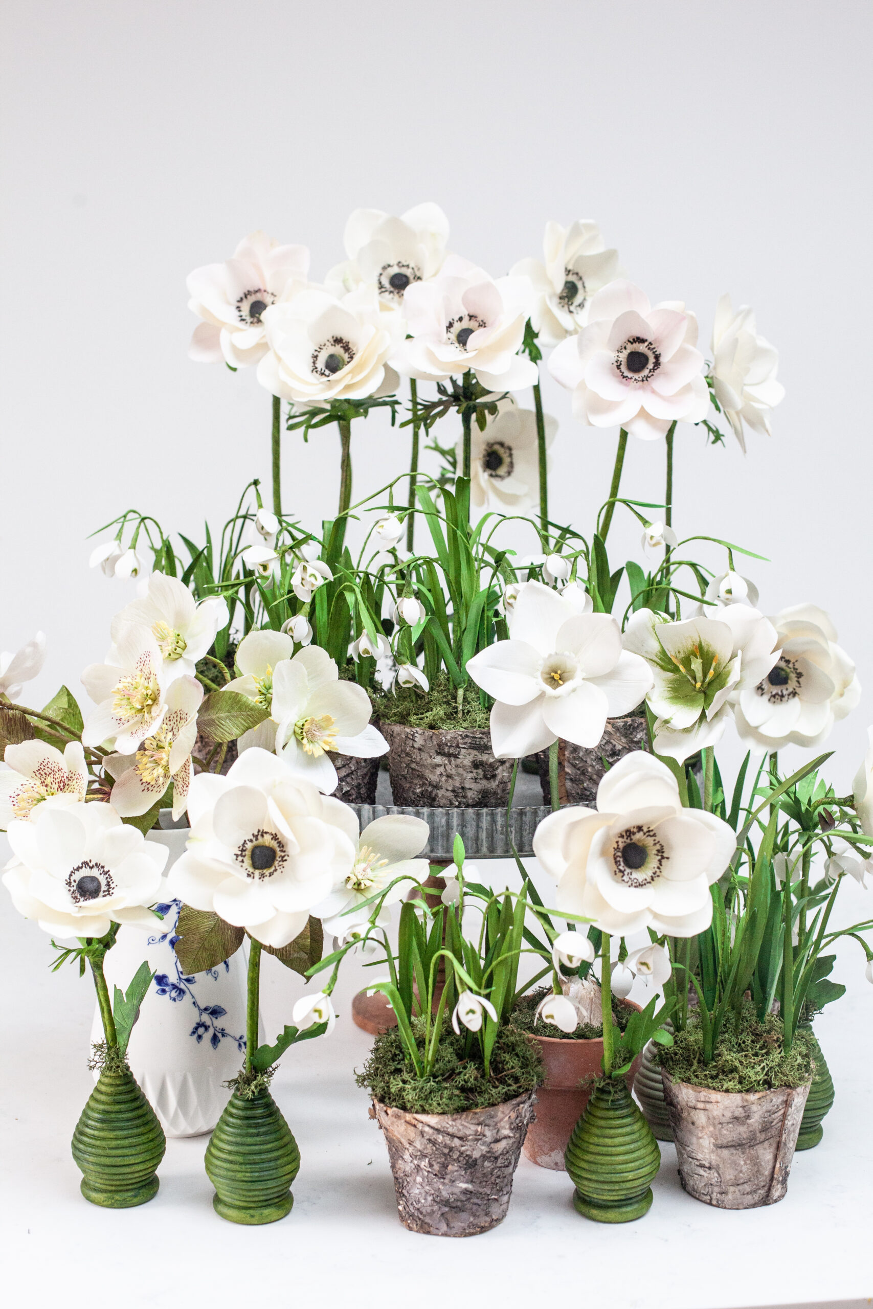 A collection of handcrafted white flowers in plant pots by Krishanthi