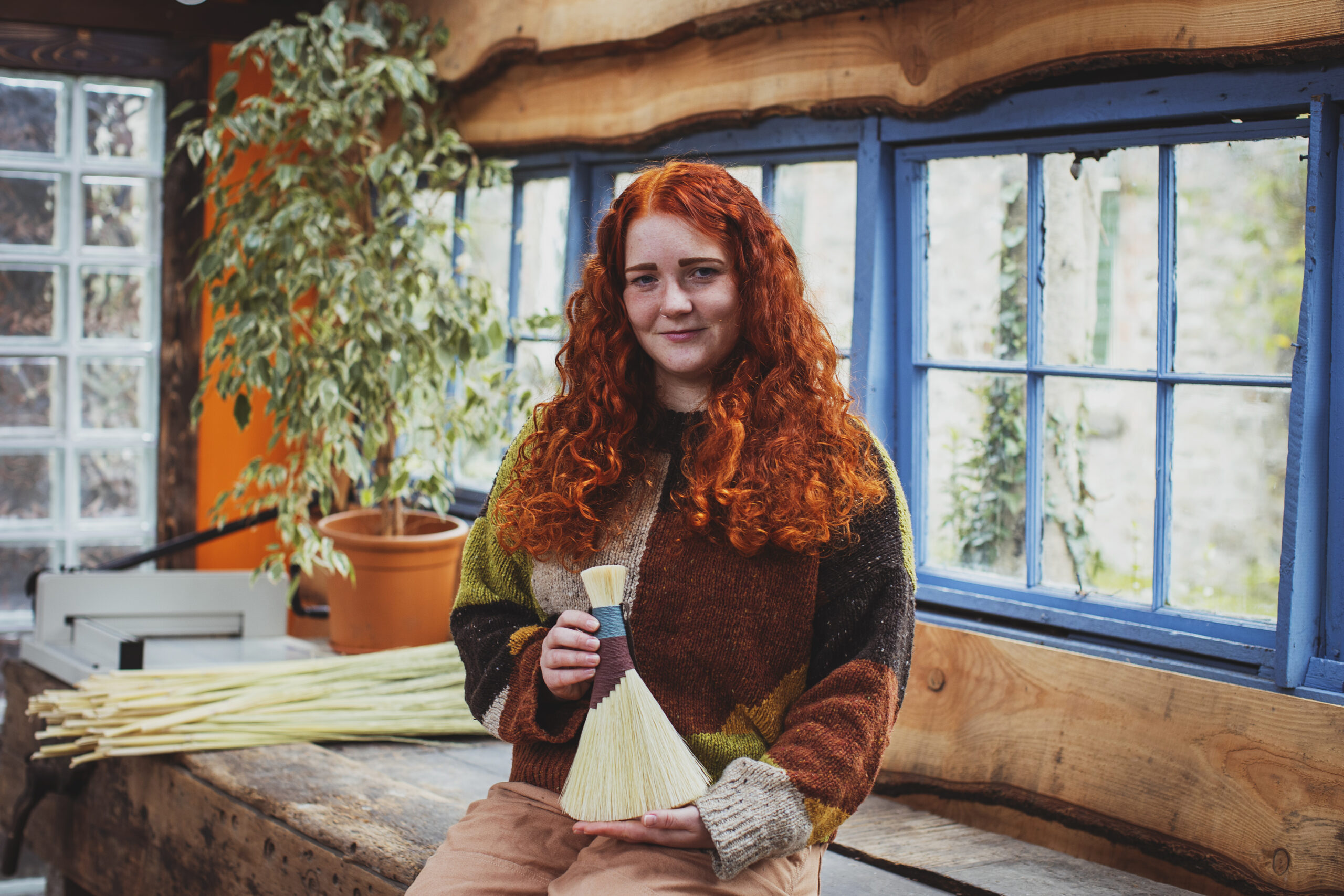 Rosa Harradine in her workshop, holding one of her handmade brushes