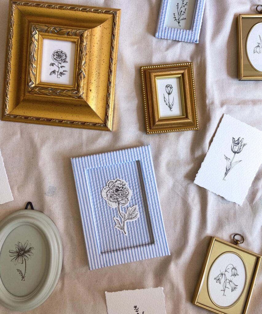 Mini dot-art floral pieces by Catherine, in second-hand frames - some gold, some painted, some striped fabric