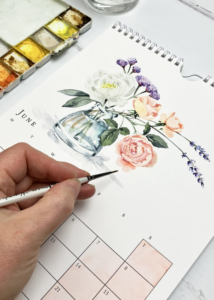 Harriet de Winton's hand painting a watercolour vase of flowers