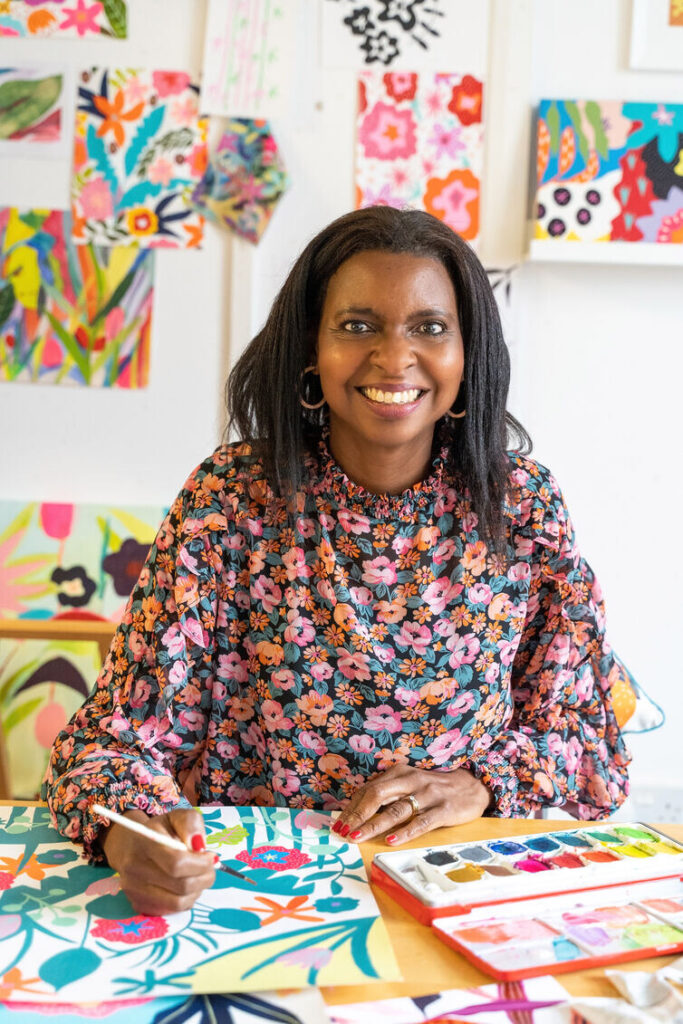 Jennie Fynn in her studio, painting a colourful pattern