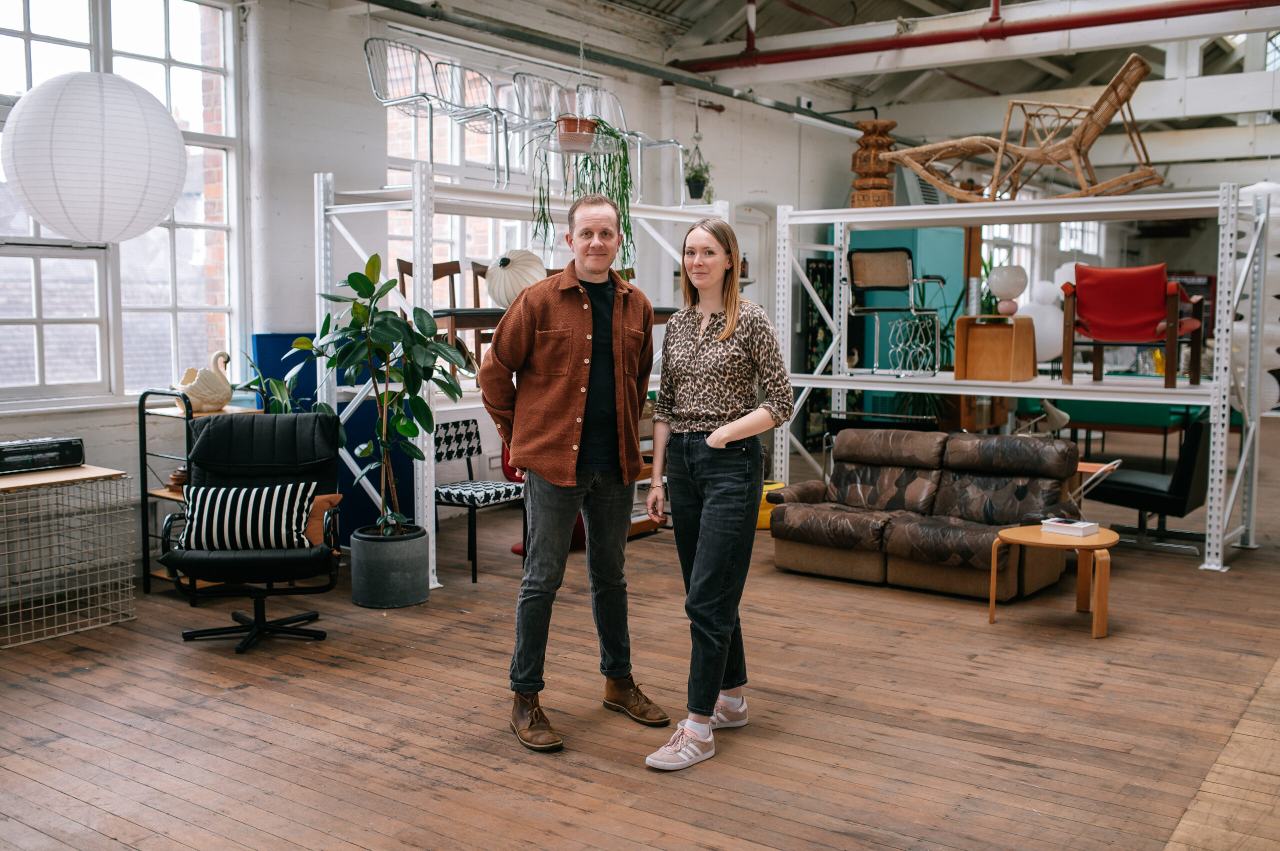 Holly and husband Pete from Holly Booth Studio, standing in a creative warehouse studio space