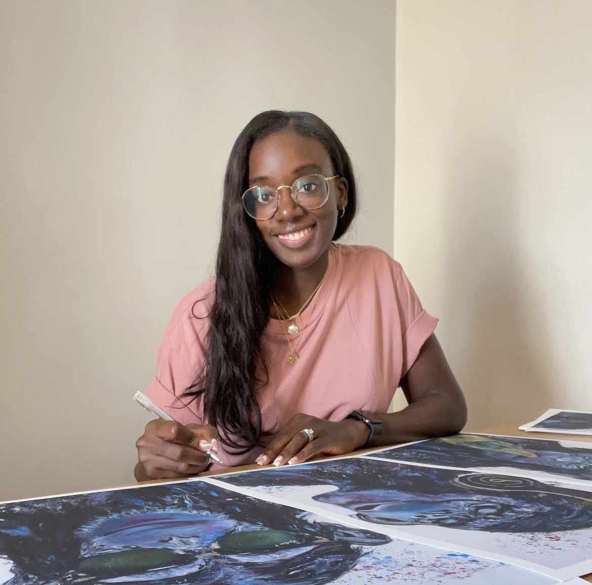 Abi from Crafty Tinks sat at her desk, drawing