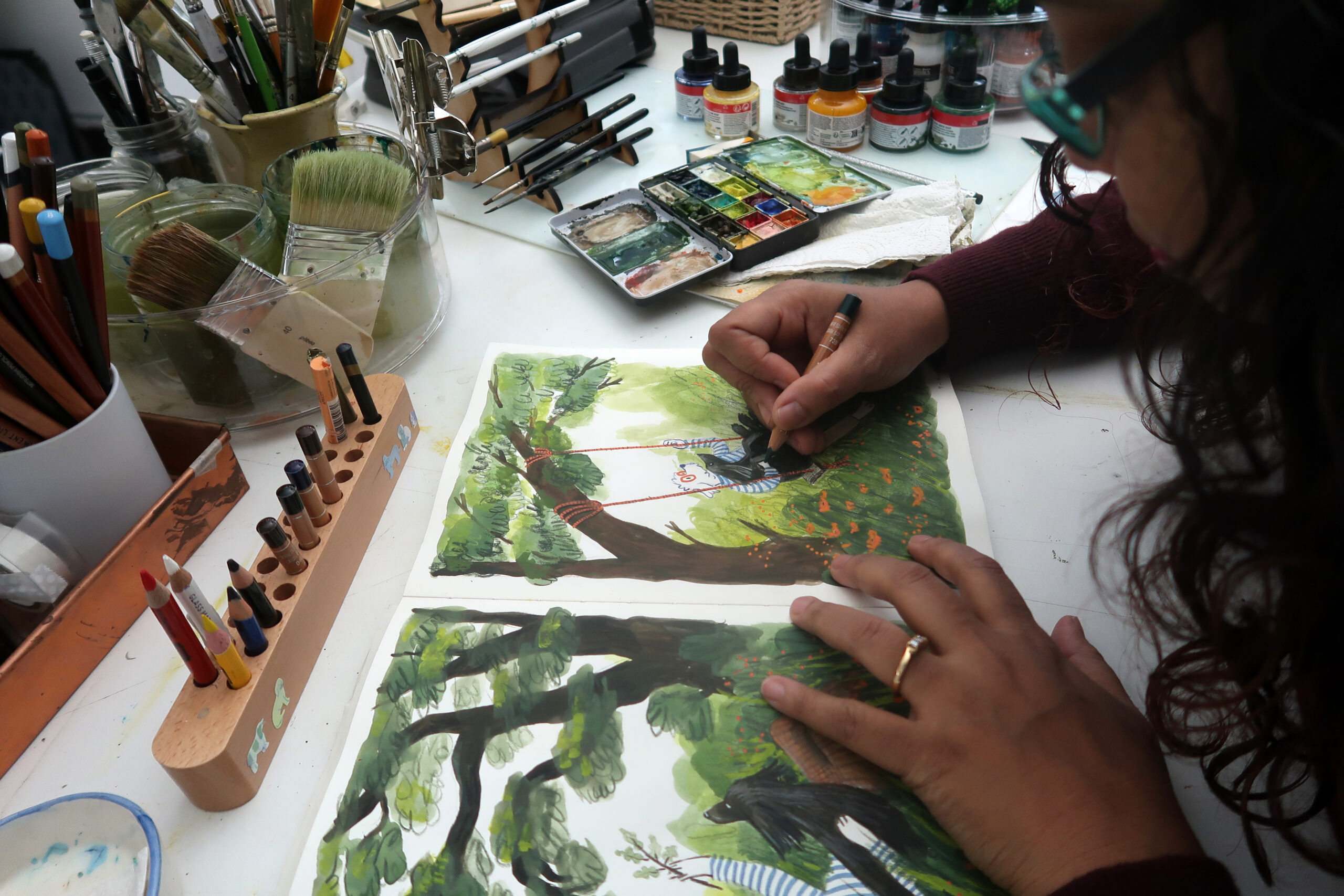 Arati Devasher creating an illustration at her desk