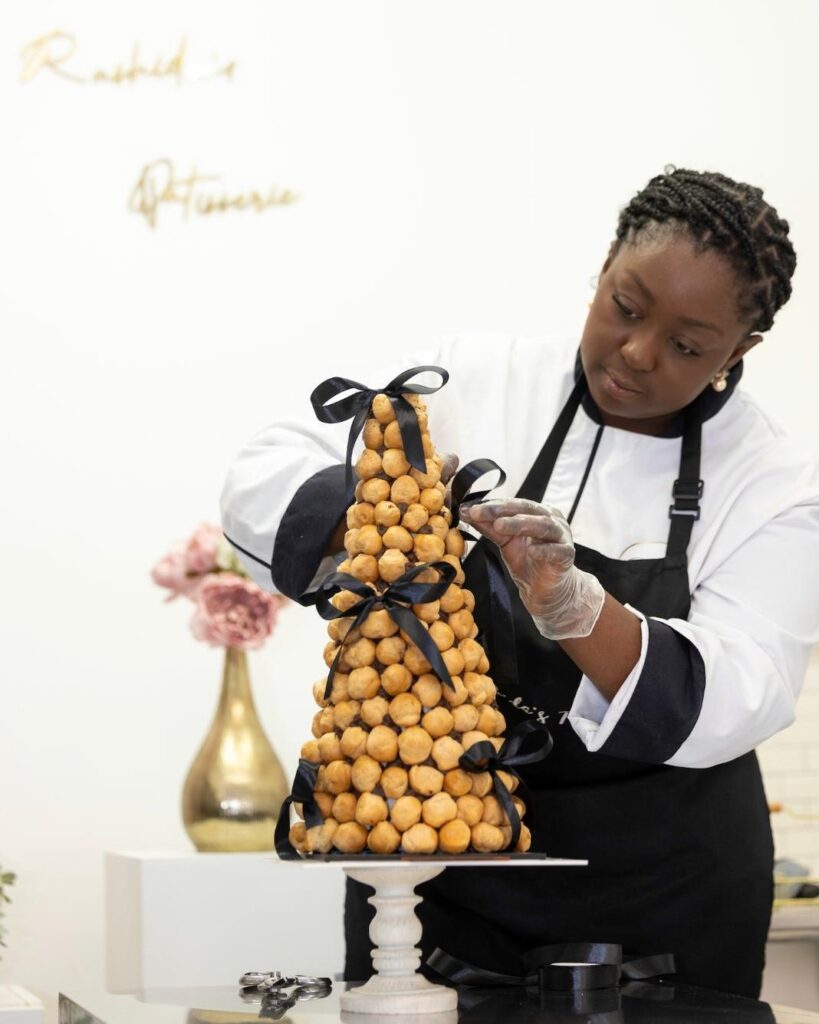 Rashida from Rashida's Patisserie creating a croquembouche tower