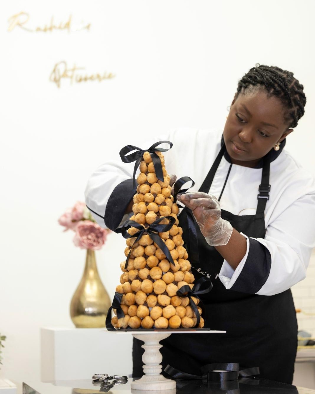 Rashida from Rashida's Patisserie creating a croquembouche tower