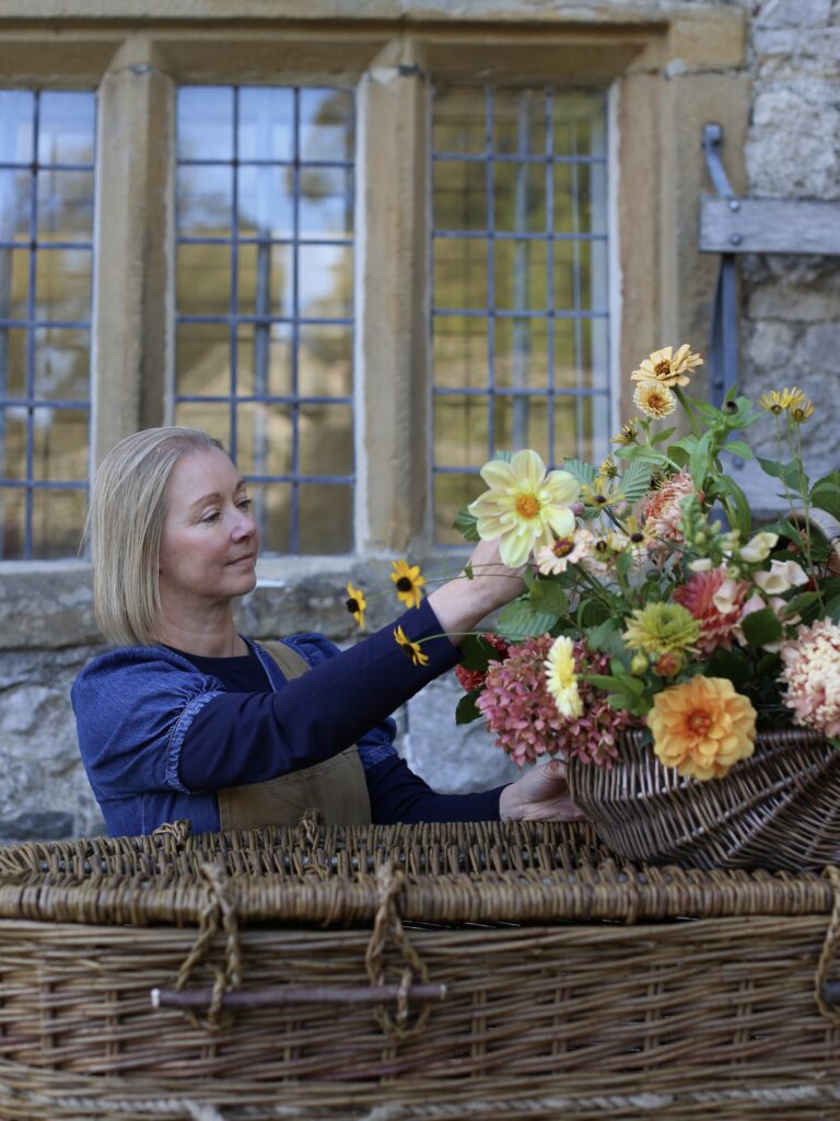 Tracey from Wild Soul Flowers, adding the finishing touch to a funeral arrangement