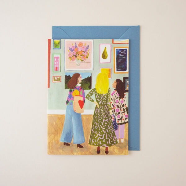 Art Lovers Gallery illustrated card by Peggy & Kate, with an illustration (originally hand illustrated in gouache and pencil) of three women chatting in an art gallery. The envelope is mid-light blue.