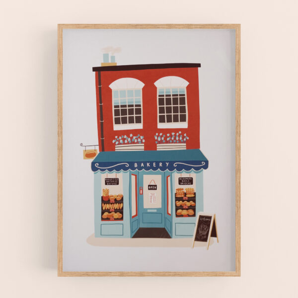Bakery shop illustration art print by Emily Nelson - with earthy red, blue, and beige colour palette. Shown in a light wood frame mockup, with a warm cream wall behind.