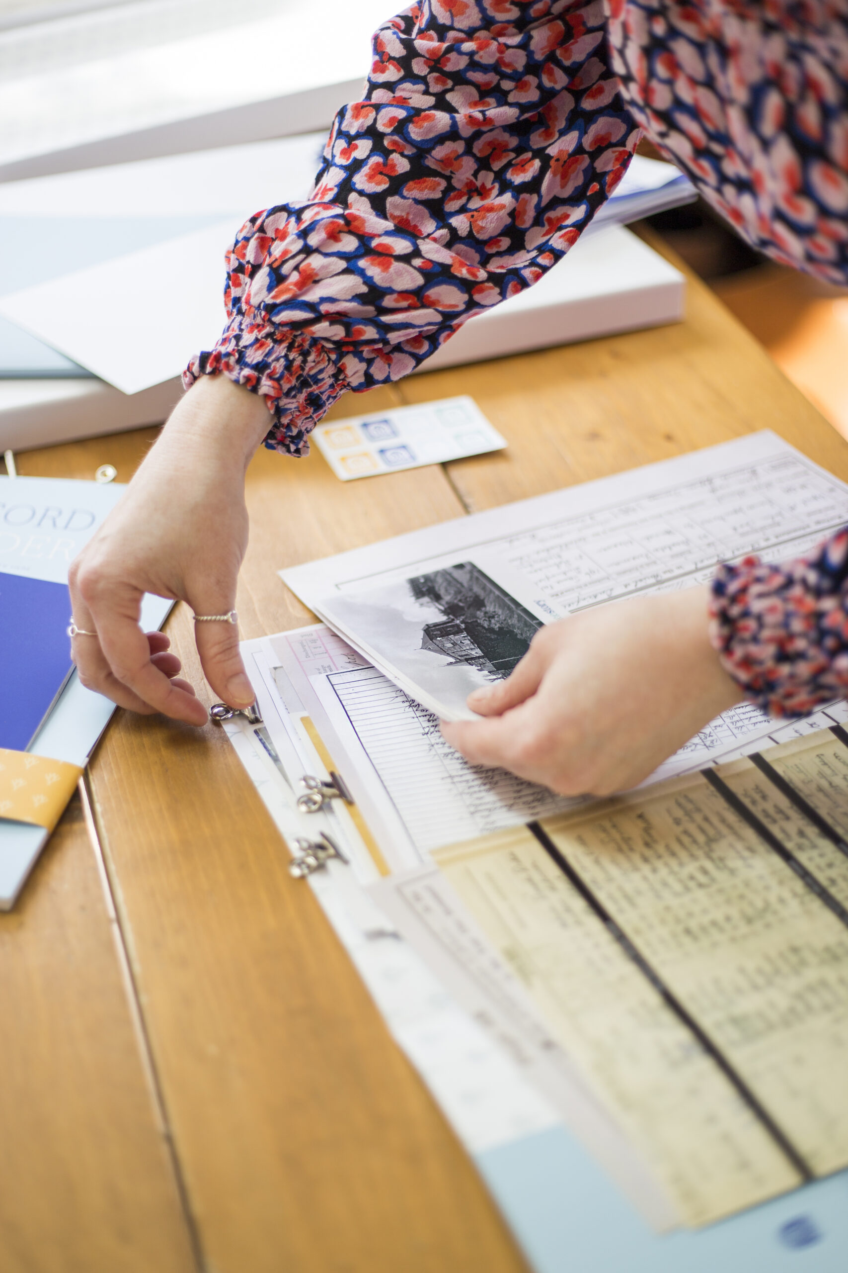 Brand photograph by Lucy Hannah Photography showing a woman's hands organising business papers