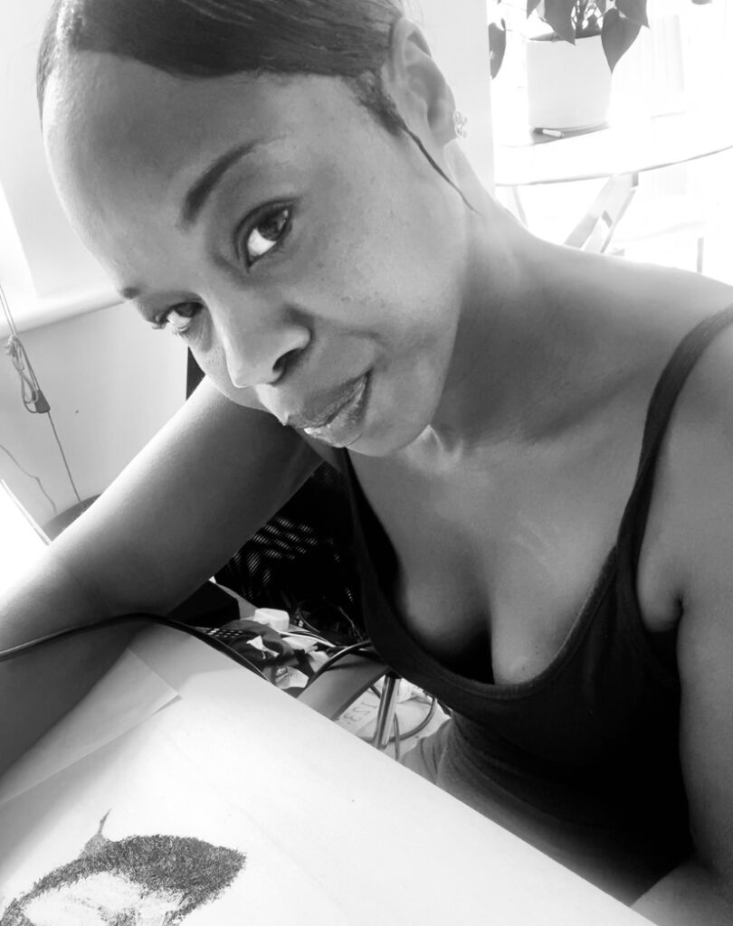 Pyrography artist, Elaine Buchanan, at her desk, creating a piece