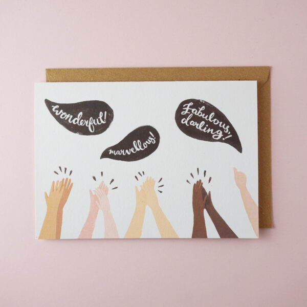 Clapping hands congratulations card by Jade Fisher, with an illustration of different skin colour women's hands clapping and black speech bubbles with the words 'wonderful', 'marvellous', and 'fabulous darling' on the front. The envelope is brown kraft.