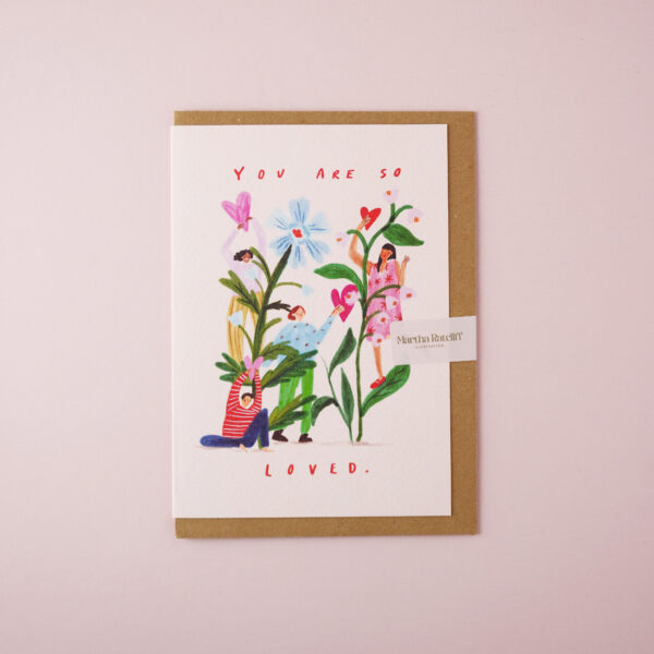 'You are so loved' illustrated card by Martha Ratcliff Illustration, with an illustration of women amongst giant flowers on the front. The envelope is brown kraft.